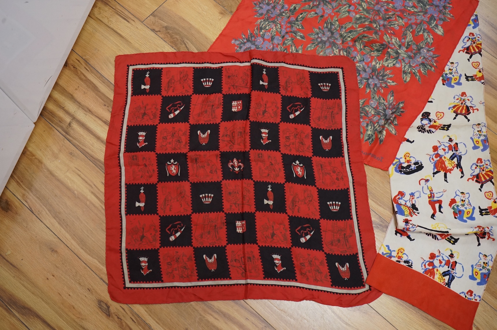 A novelty cartoon style Jacqmar silk scarf, two others and two unnamed scarves
